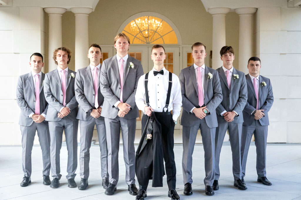groom and groomsmen wedding party pose at ashton gardens wedding venue