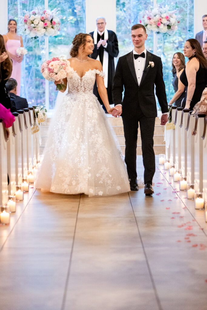 bride and groom walking down the aisle at ashton gardens in atlanta