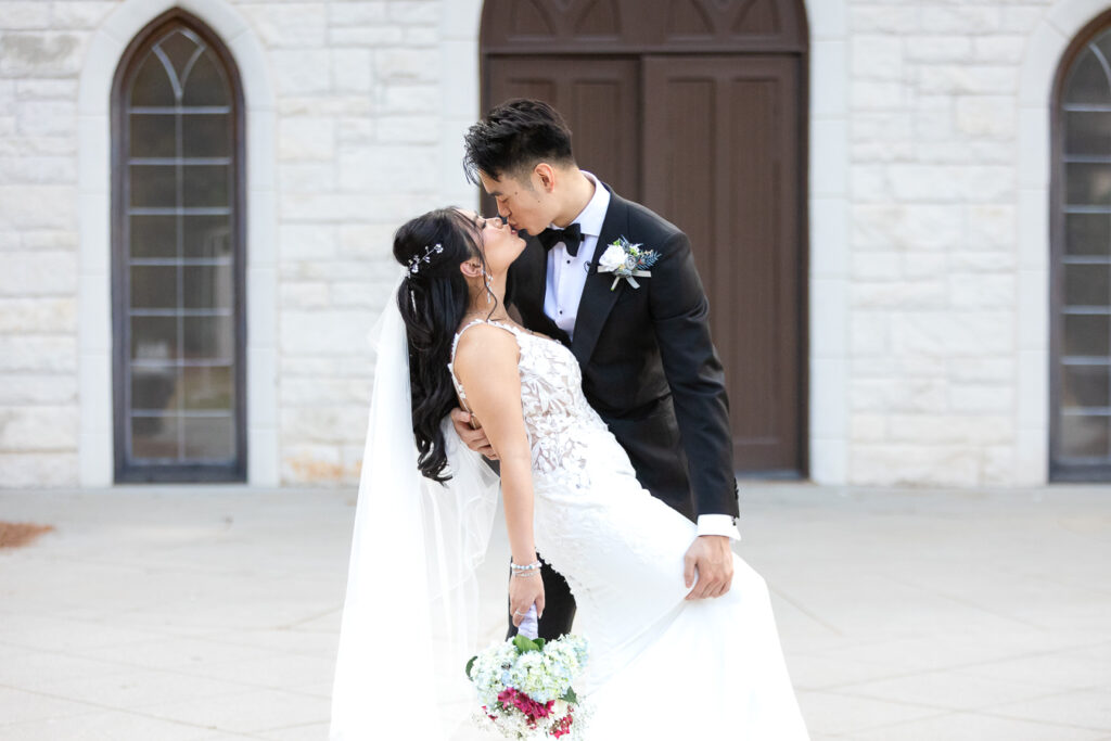 Newlywed couple shares an intimate kiss outside ashton gardens wedding venue in Atlanta