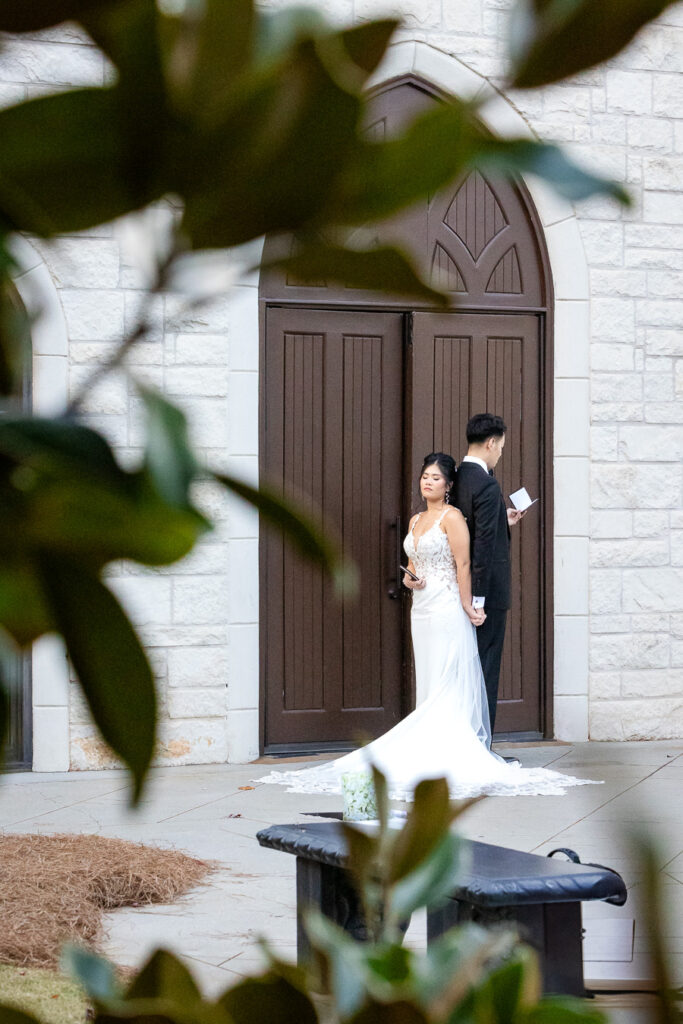 bride and groom doing a first touch and vows at their wedding at Ashton Gardens