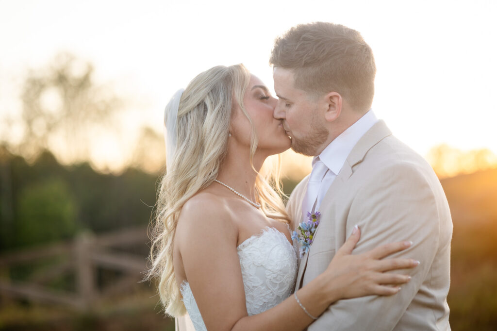 bride and grom kissing during golden hour