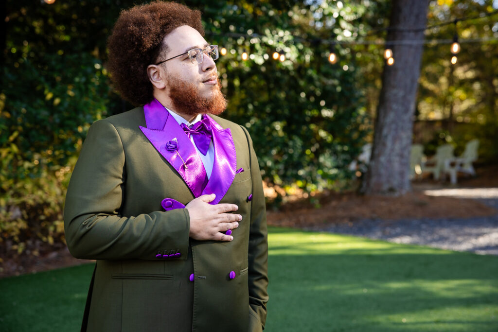 groom poses at his wedding at four oaks manor