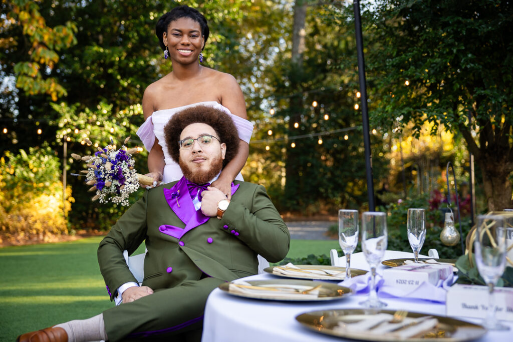 bride and groom poses at their wedding at four oaks manor