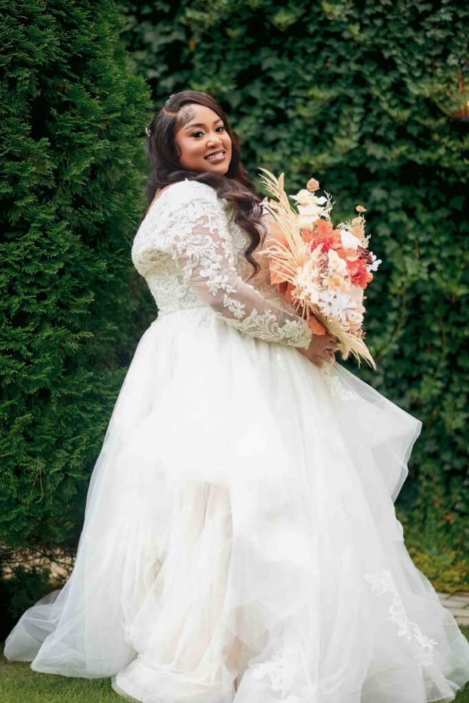 bride poses during his wedding at Castle at Wildwood gardens