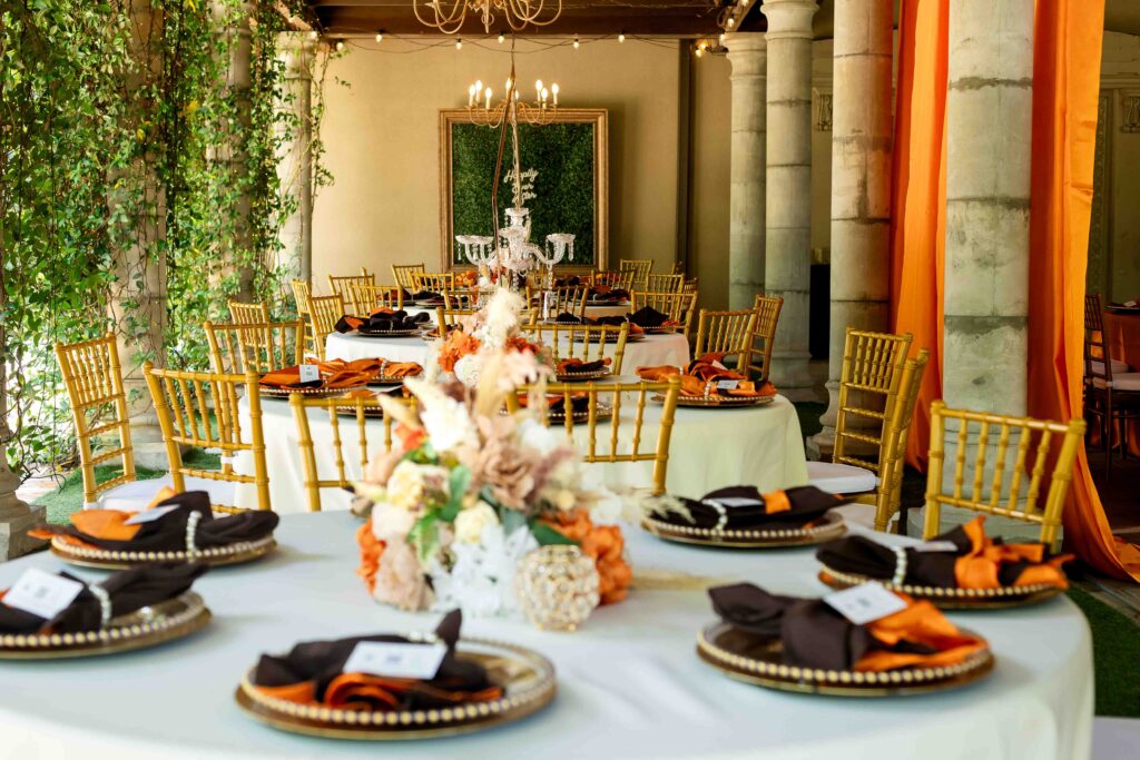The Castle at Wildwood Gardens reception with chandeliers, string lights, and elegant gold accents.