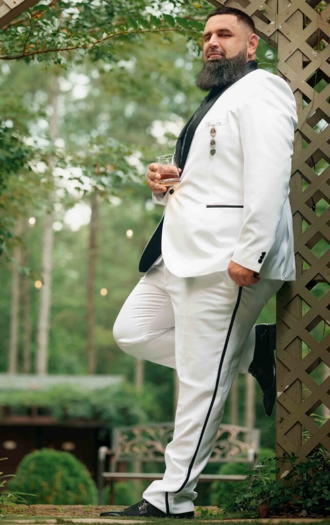 groom poses during his wedding at Castle at Wildwood gardens