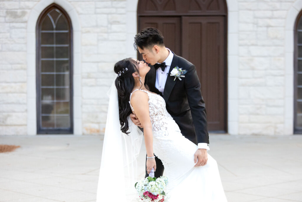Newlywed couple shares an intimate kiss outside ashton gardens wedding venue in Atlanta