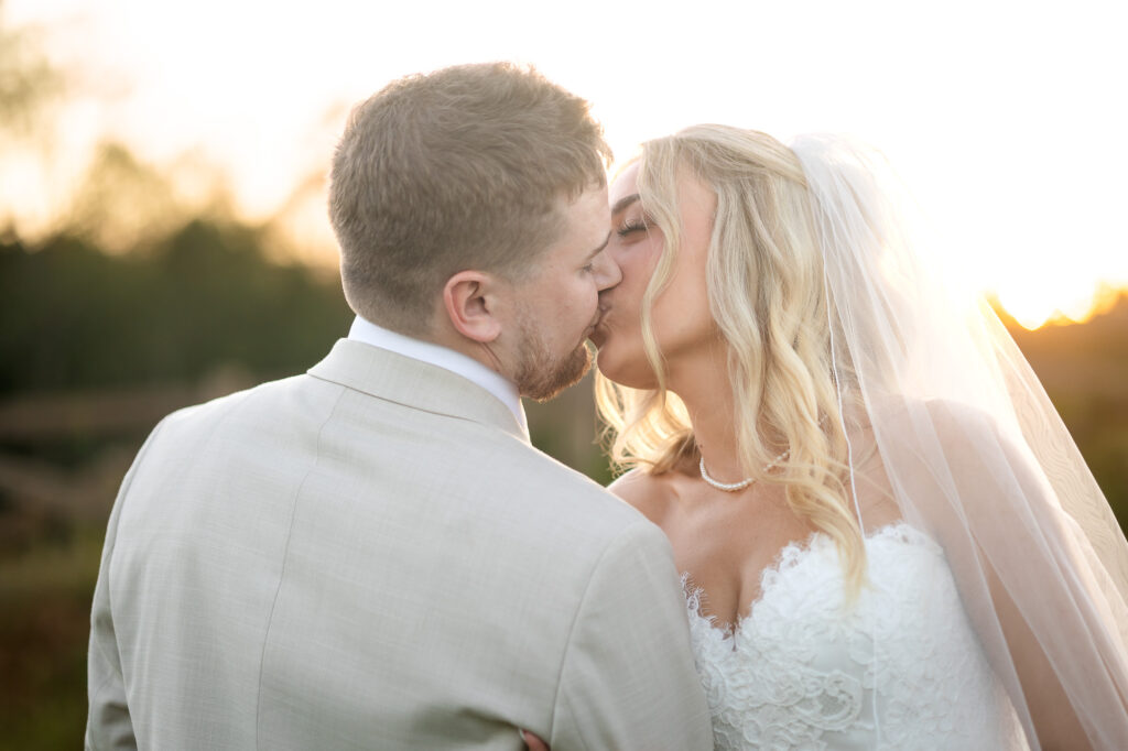 A romantic wedding couple shares tender moments at sunset at a vineyard in Georgia