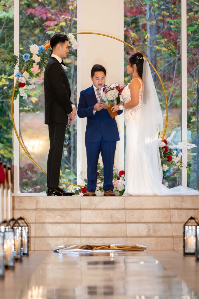 A couple stands together during their wedding ceremony at ashton gardens wedding venue