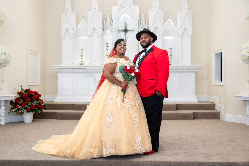 a couple takes their wedding photo inside pristine chapel 
