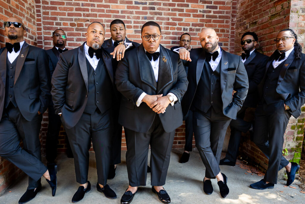 groomsmen posing outdoors at Bibb Mill Event Center, captured in natural true-to-color photography
