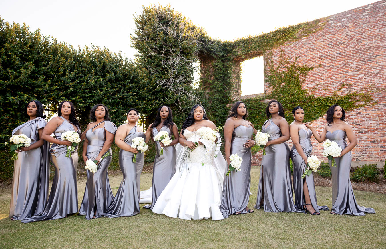 bride and bridesmaid posing at a wedding at bibb mill event center