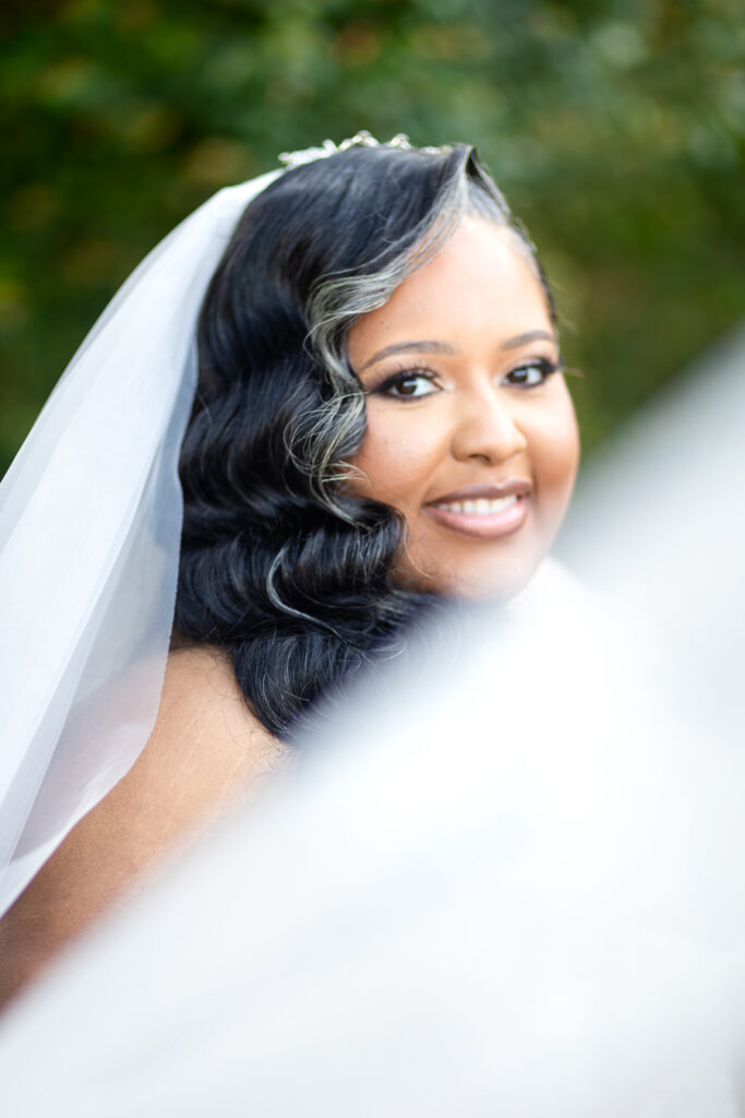 Close-up bridal portrait highlighting lace details and bouquet at Bibb Mill wedding