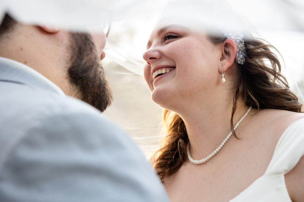intimate golden hour moment under veil  during wedding at beautiful beginnings farm 
