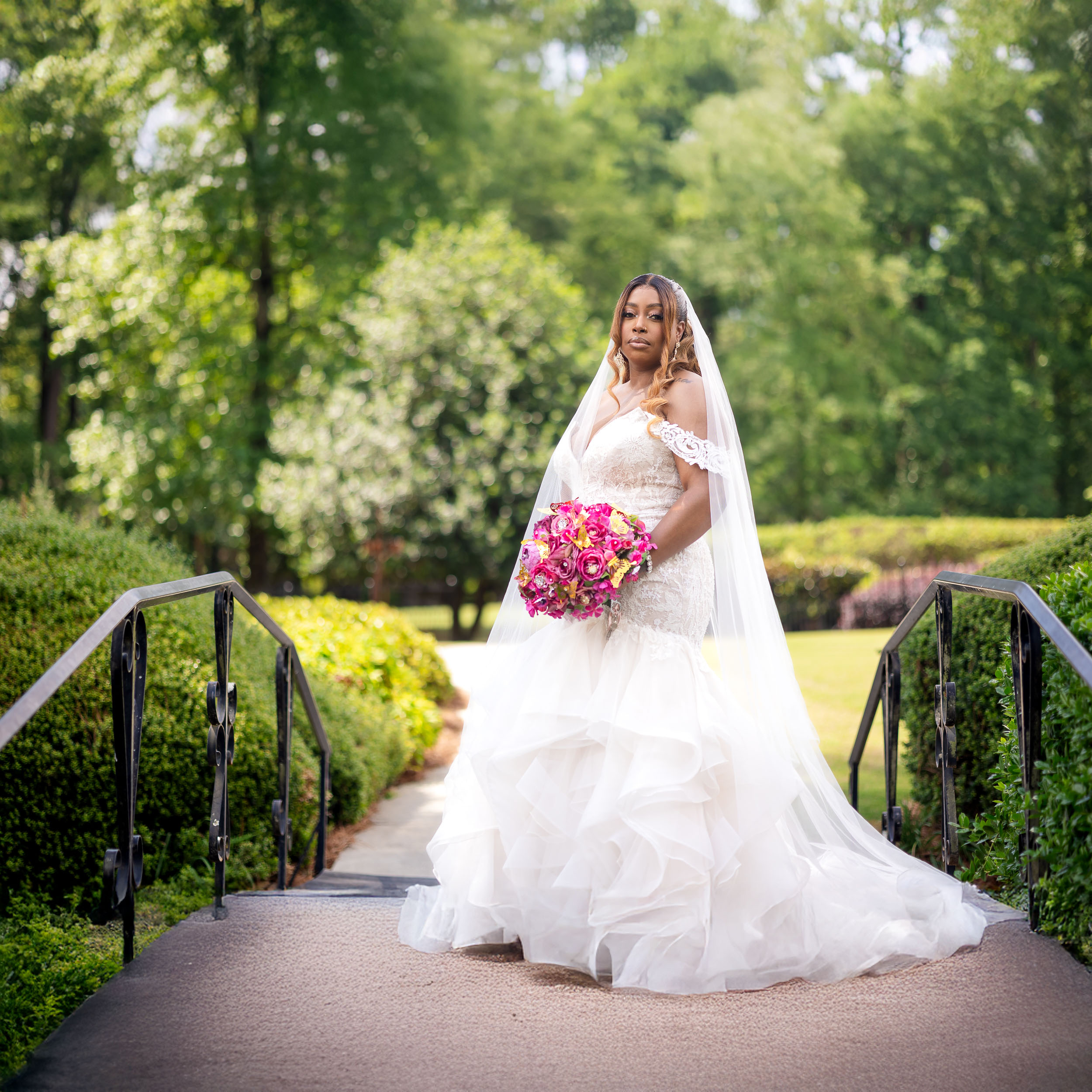 a bride posing on a bridge at Pristine Chapel during her wedding