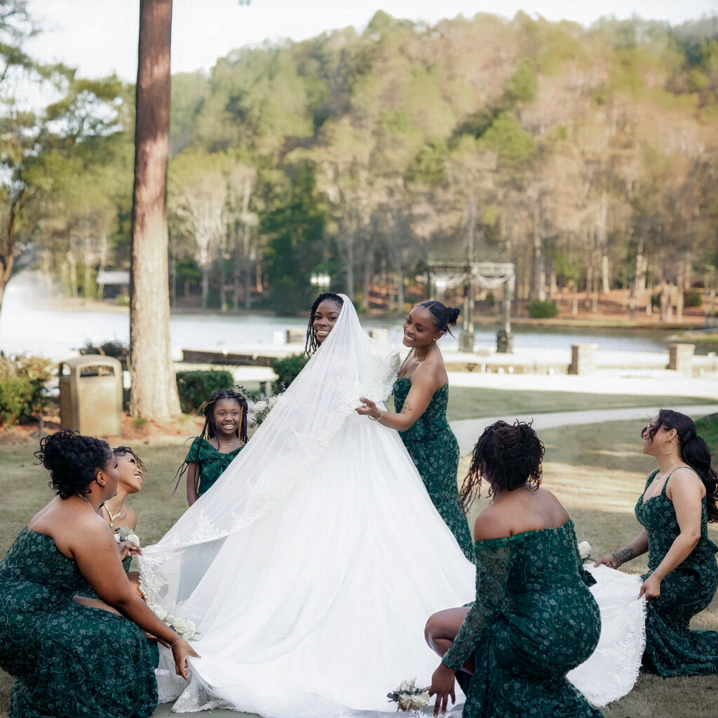  bridesmaids fixing brides dress during the wedding at Pristine chapel in Atlanta 