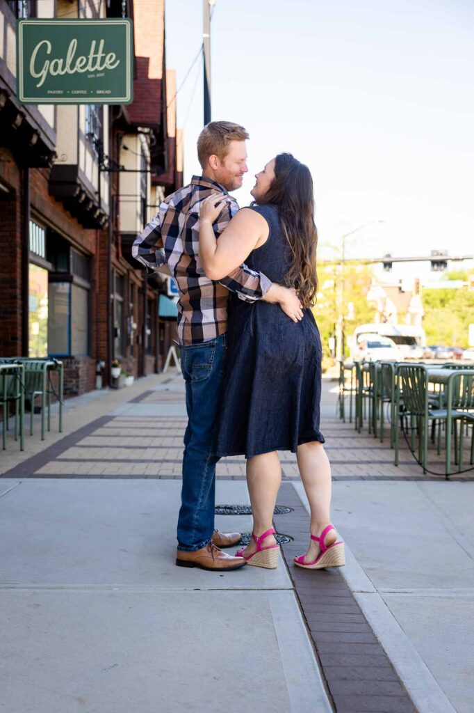 Atlanta engagement photographer capturing couple laughing in downtown Decatur streets