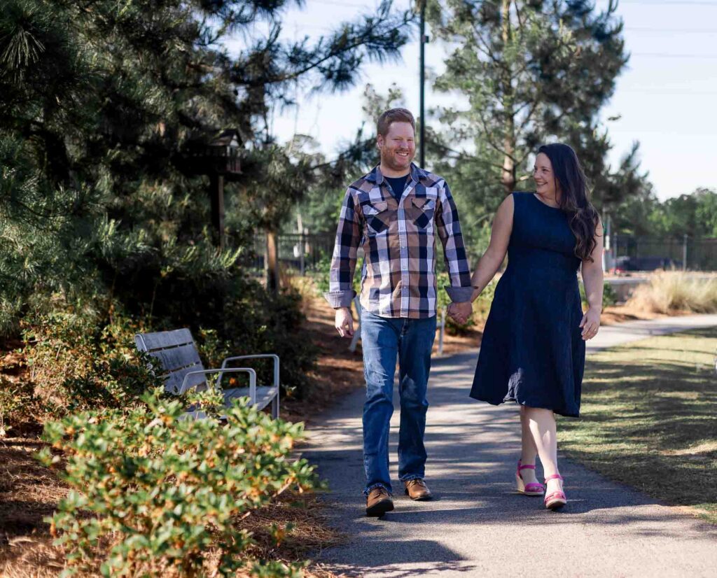 Couple walking hand in hand through downtown Decatur Georgia engagement session